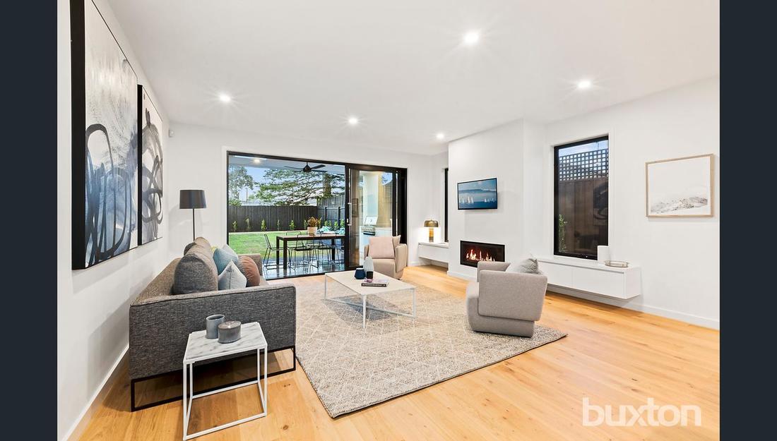 A living room with a couch , chairs , and a fireplace.