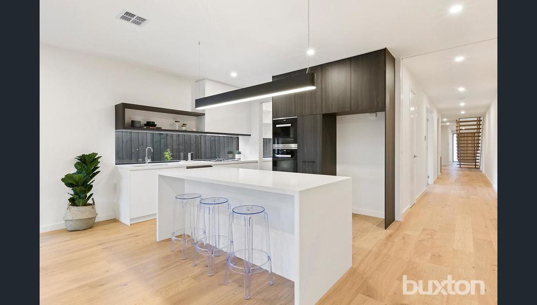 A kitchen with a large island in the middle of the room.
