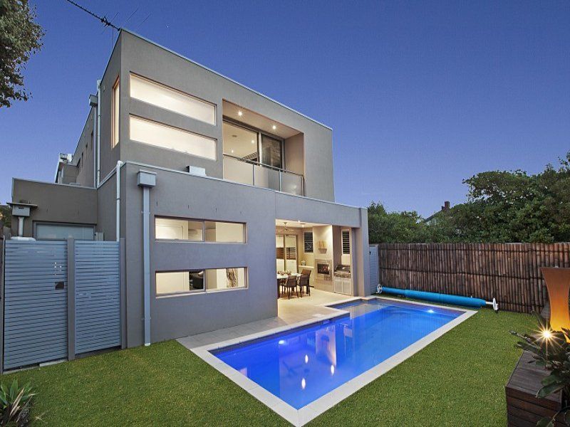 A modern house with a large swimming pool in the backyard