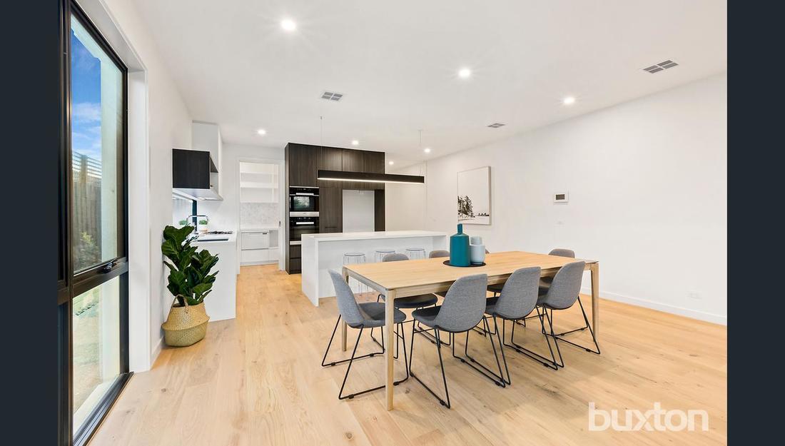 A dining room with a table and chairs in a house.