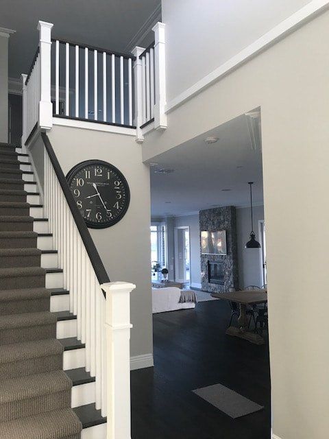 A staircase with a clock on the wall that shows the time as 10:10