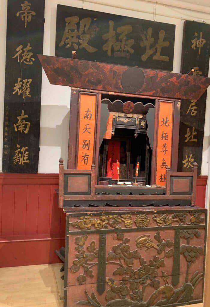 An altar from the temple in Napa's Chinatown, with elaborate decoration, as seen at the Chinese Historical Society in San Francisco.
