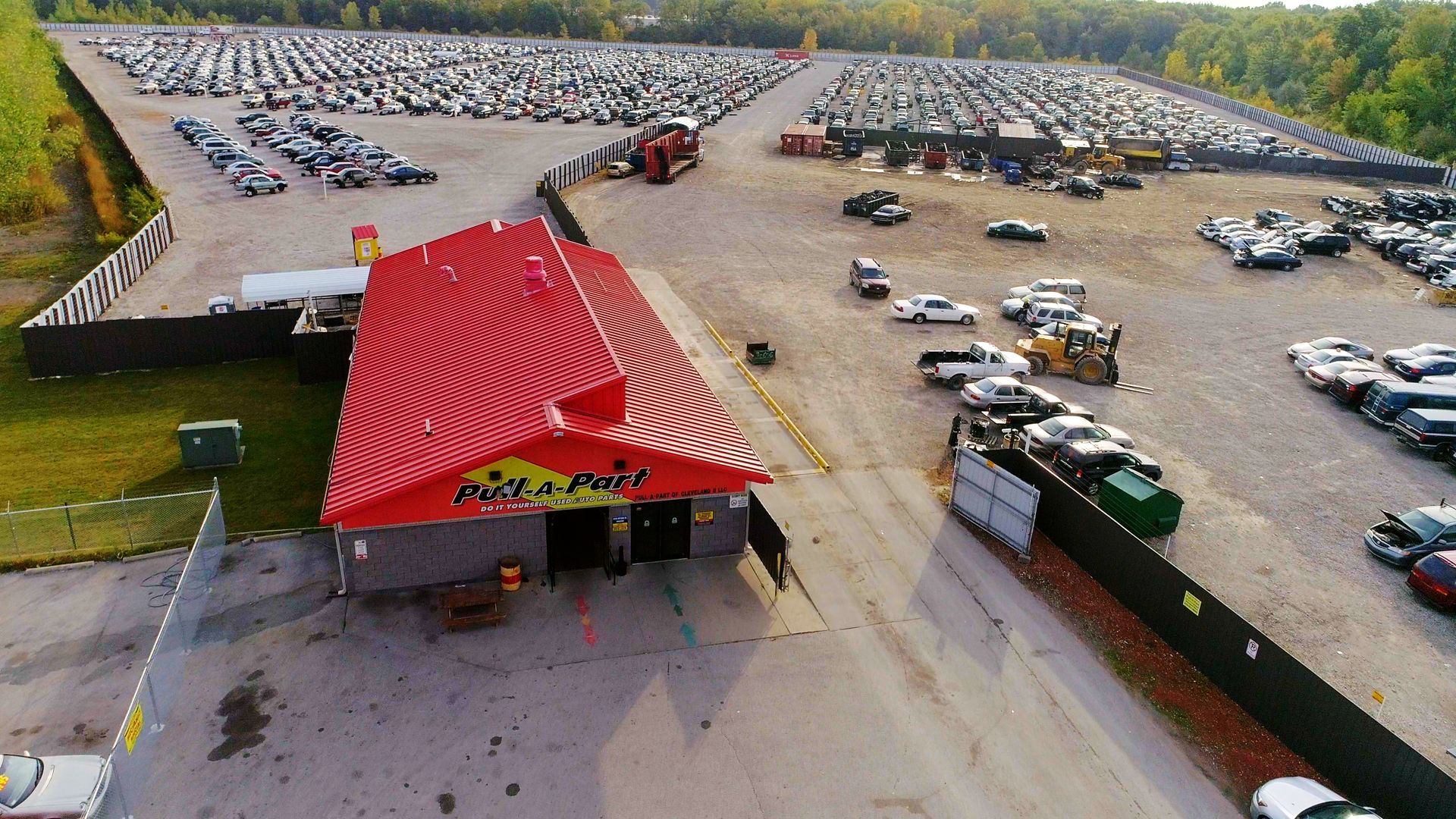 An aerial view of a a large vehicle salvage yard, cars everywhere.