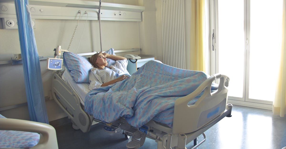 A woman is laying in a hospital bed.