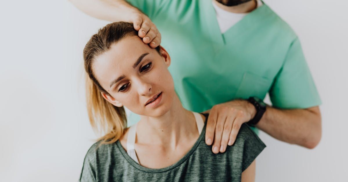 A man is giving a woman a neck massage.