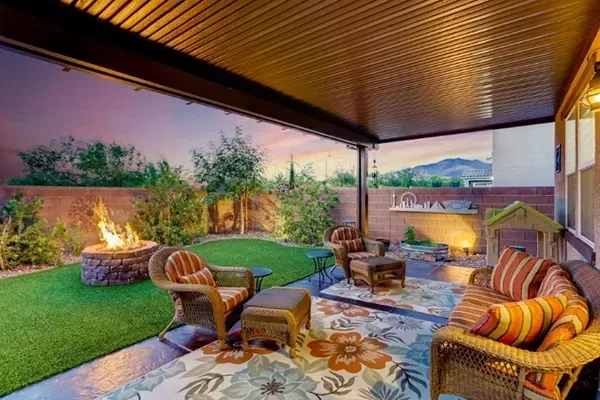 Backyard with green grass and fire pit that can be purchased with FHA Financing in Las Vegas Nevada