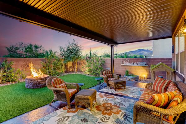 Backyard patio, grass and a fire pit in Henderson Nevada community called Inspirada