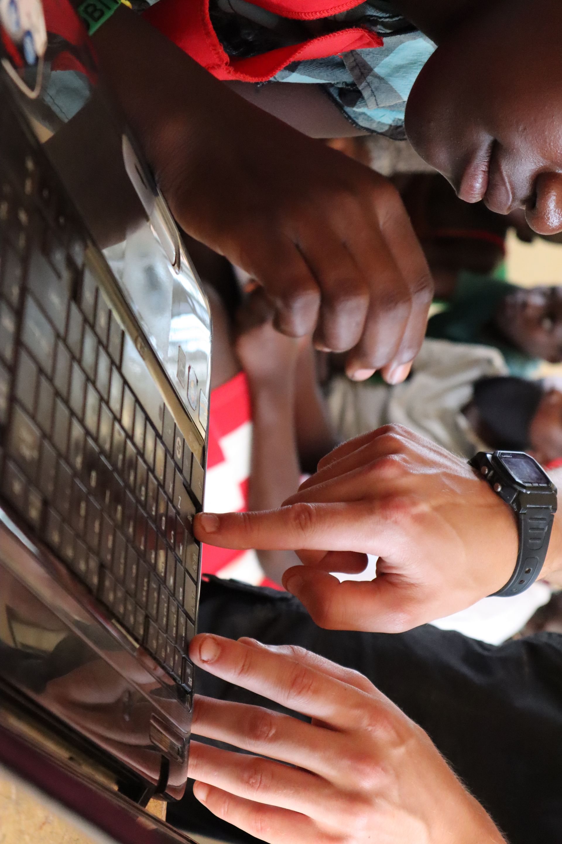 A volunteer teaching computer skills lesson