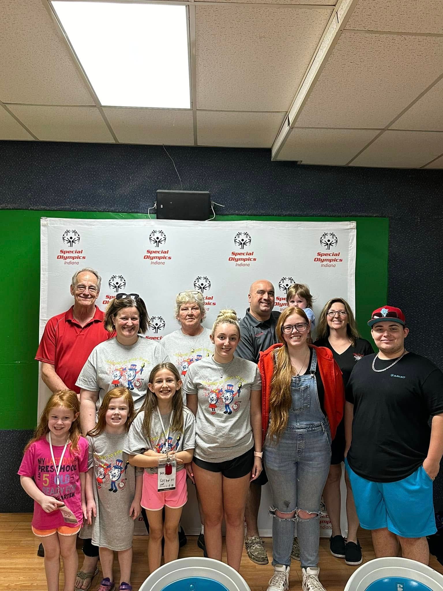 A group of people are posing for a picture in a room.