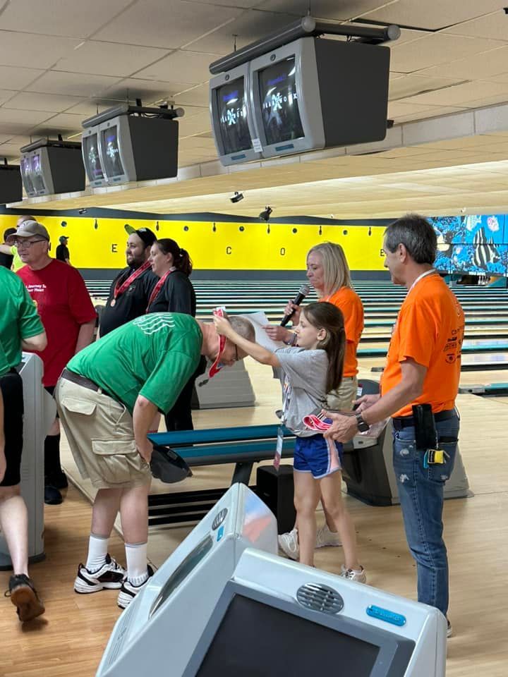 A group of people are playing bowling in a bowling alley.