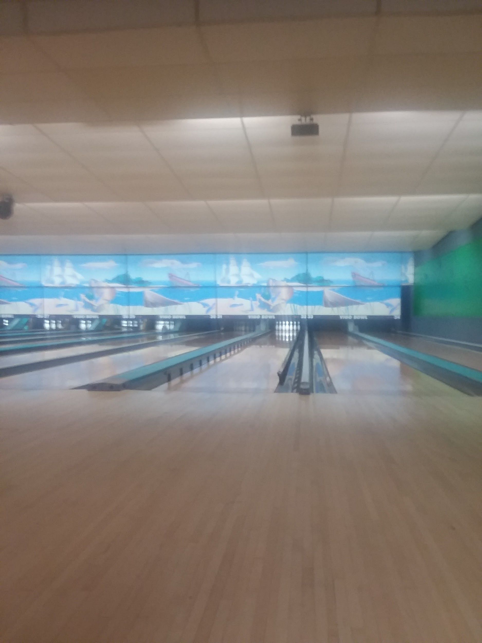 A bowling alley with a lot of bowling pins