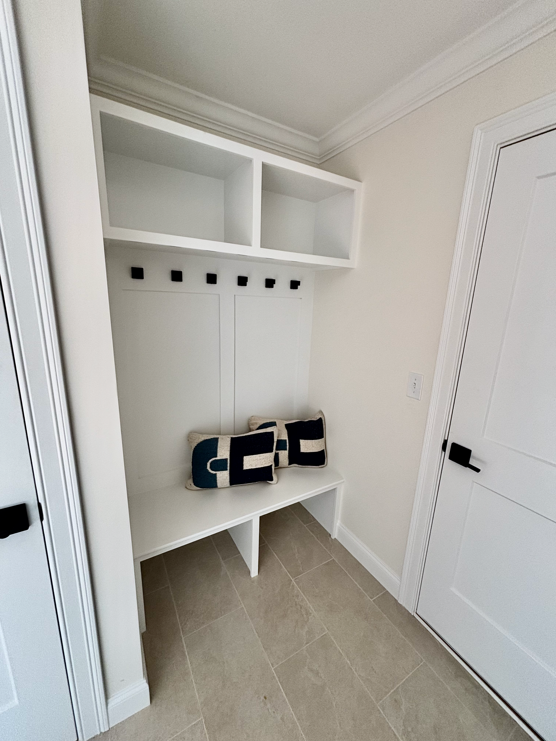 Bright, modern kitchen with white cabinets, island, and light wood flooring.