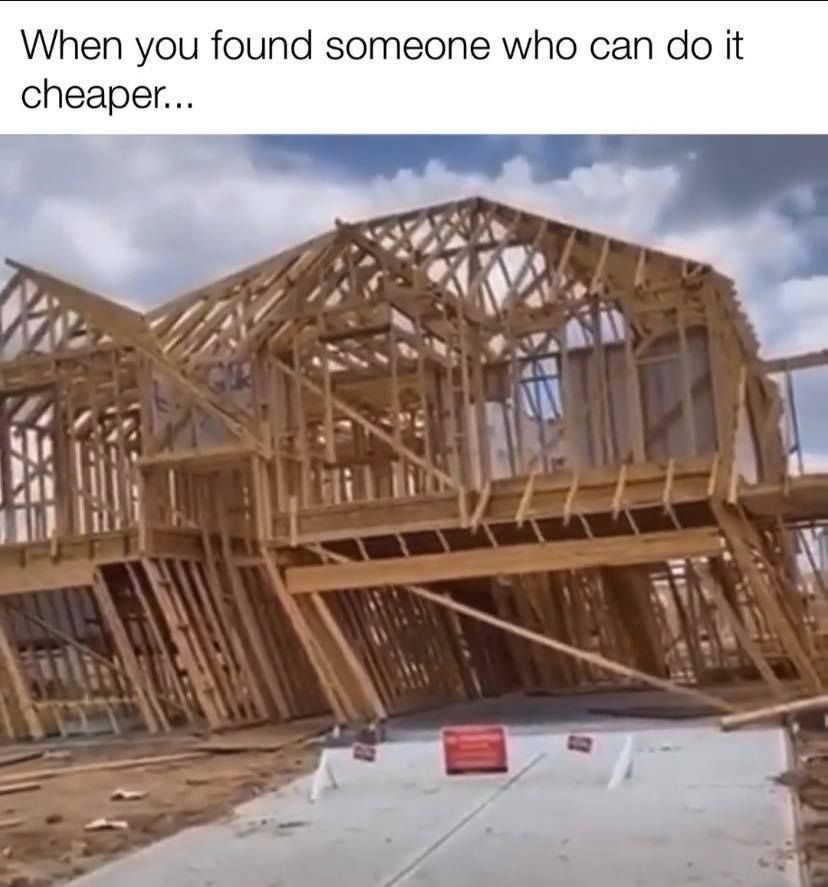 A crooked, unfinished house frame, suggesting poor construction.