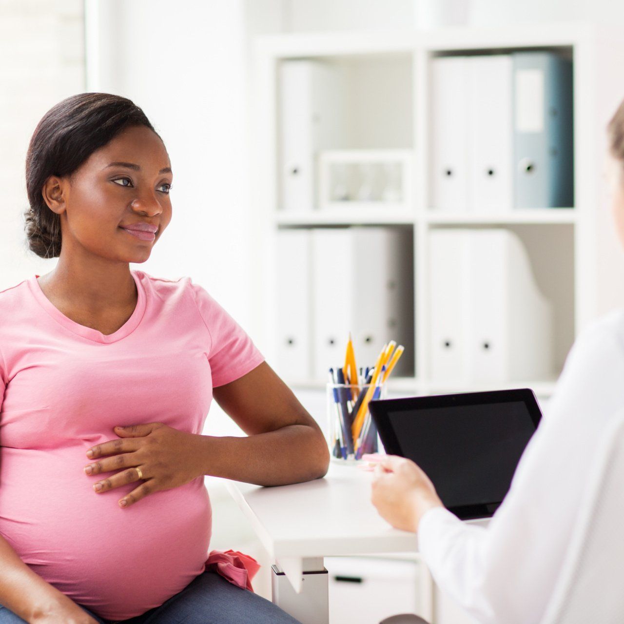 Pregnant woman being seen by a doctor