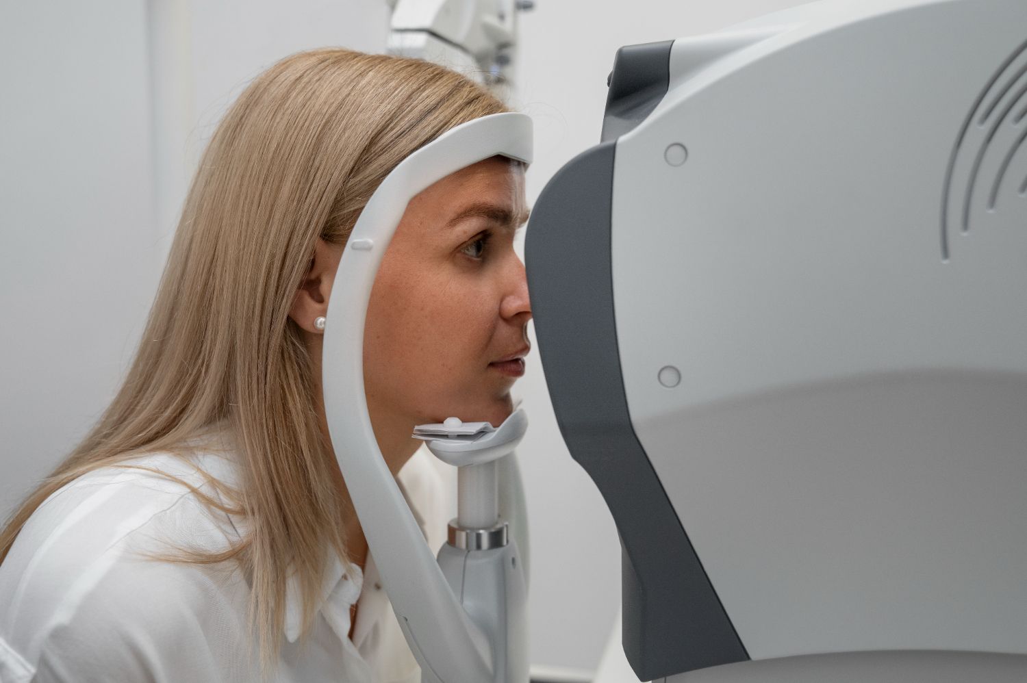 A woman is getting her eyes checked by an ophthalmologist.