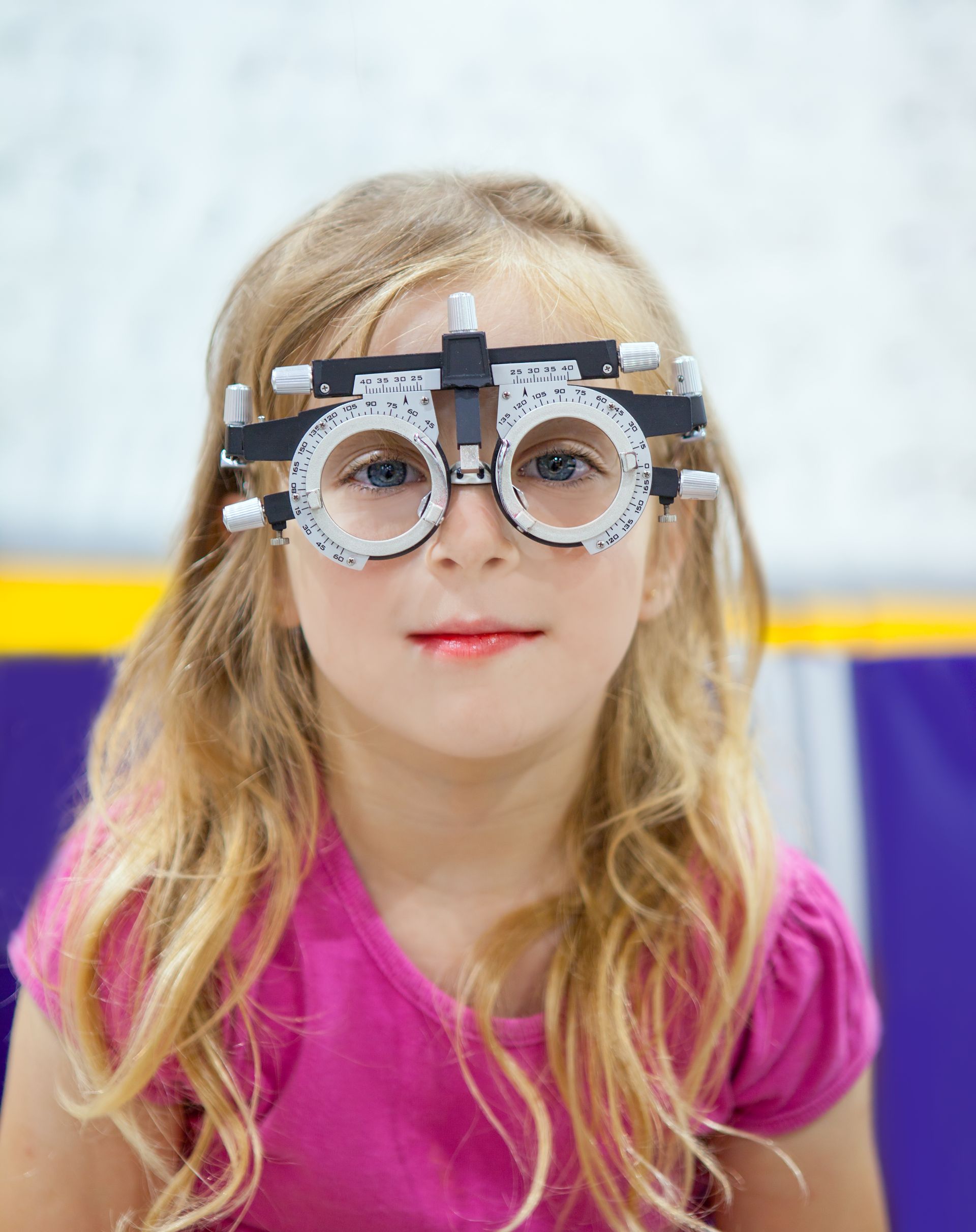 A little girl is wearing a pair of glasses.