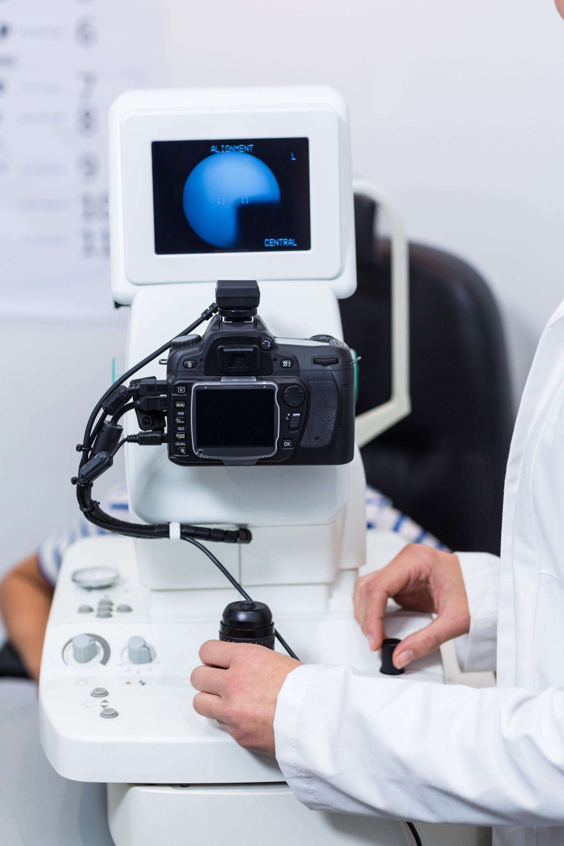 A doctor is using a camera to take a picture of a patient 's eye.