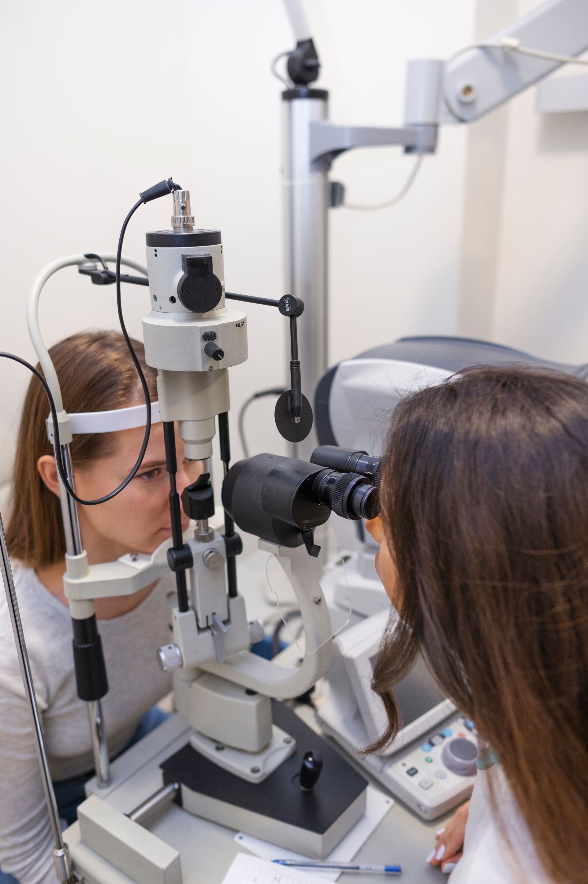 A woman is getting her eyes examined by an ophthalmologist