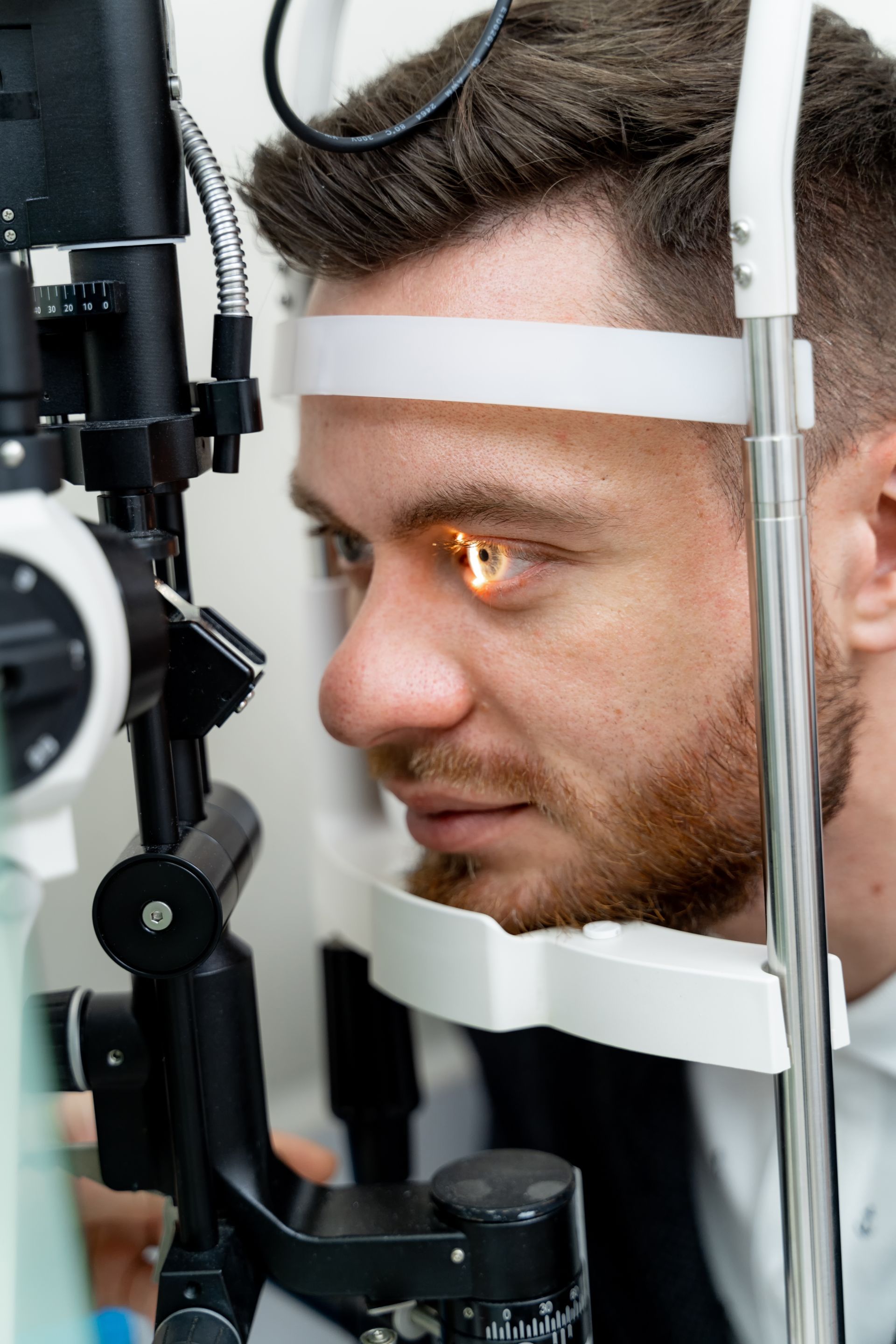 A man is getting his eyes examined by an ophthalmologist.