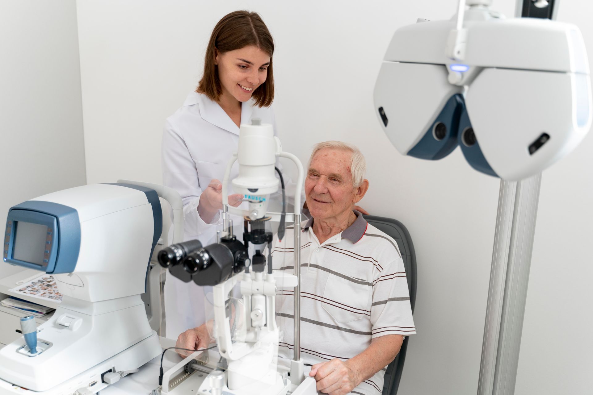 An elderly man is getting his eyes examined by an ophthalmologist.