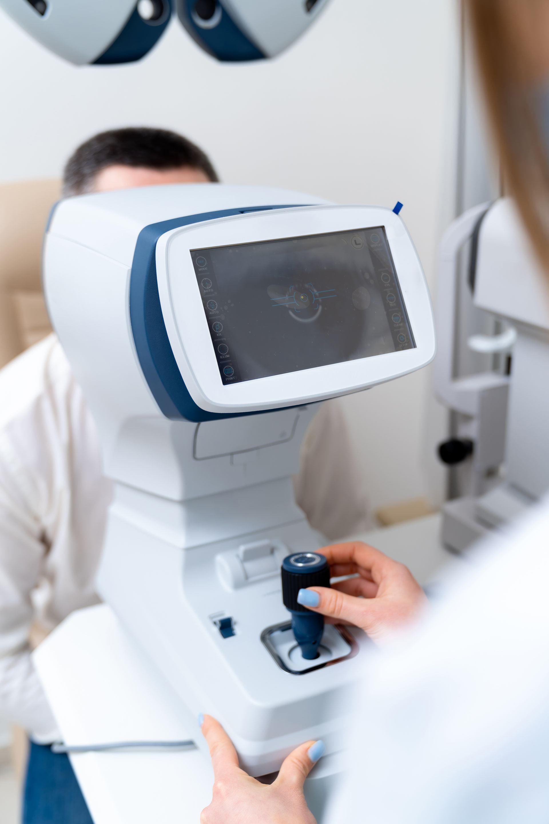 A man is getting his eyes checked by an ophthalmologist.