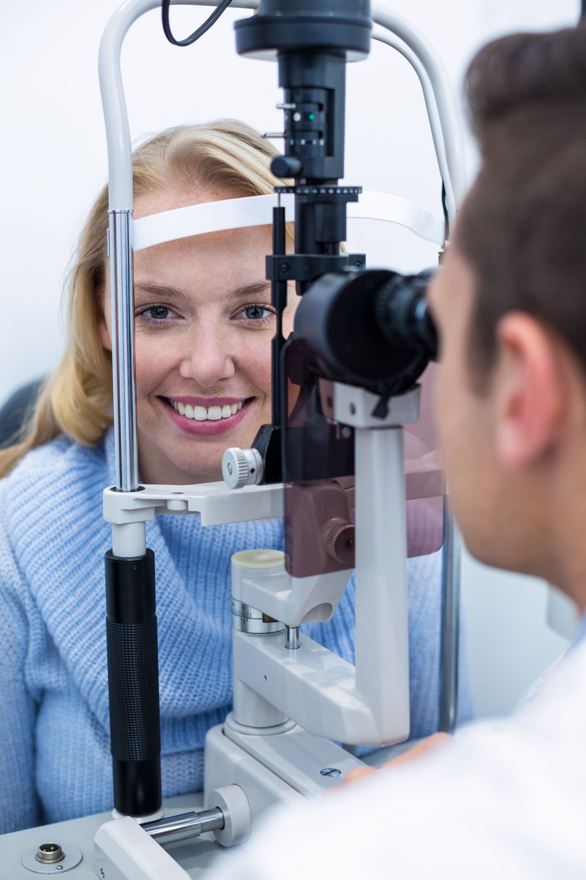 A woman is getting her eyes examined by an ophthalmologist.