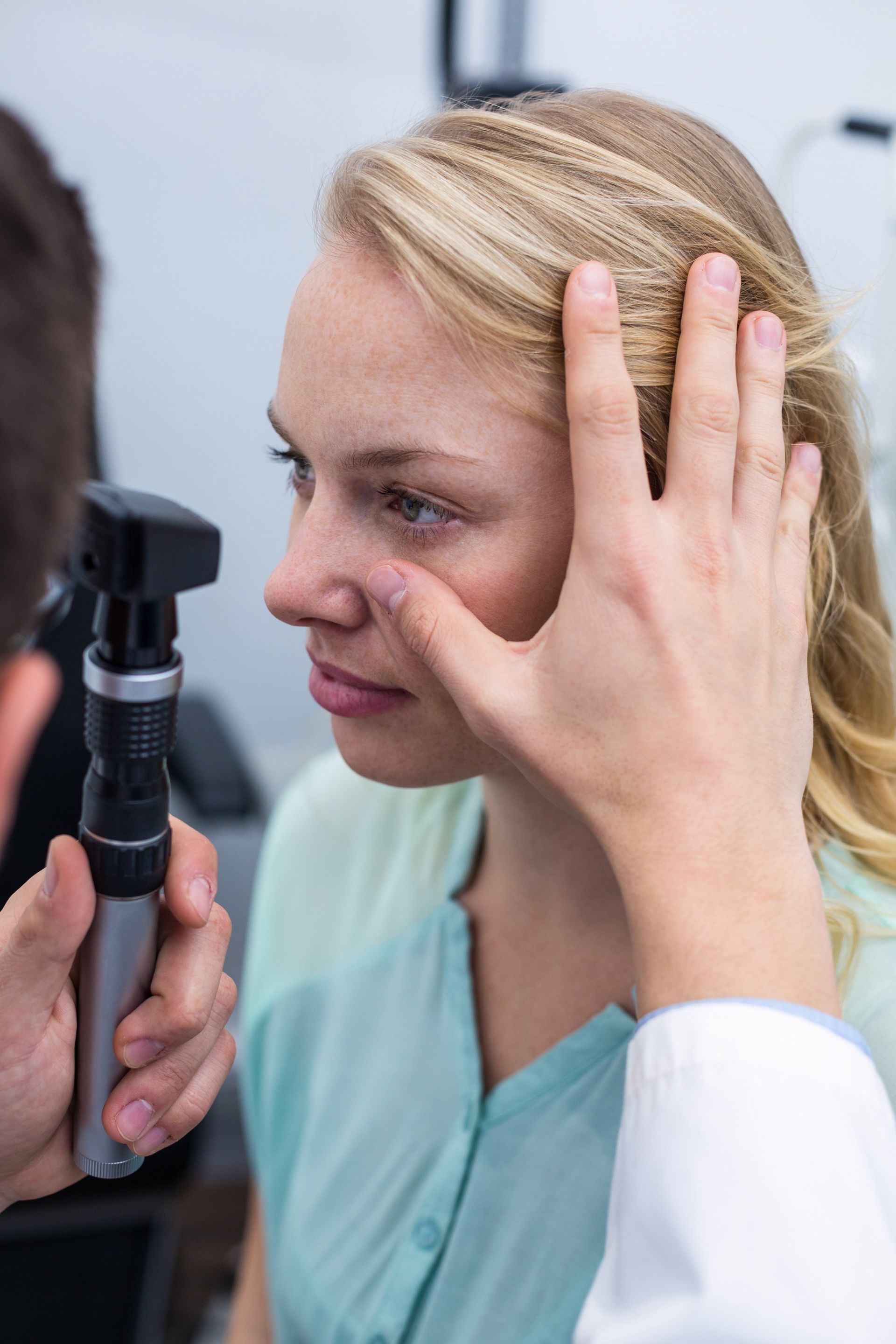 A woman is getting her eyes examined by an ophthalmologist.