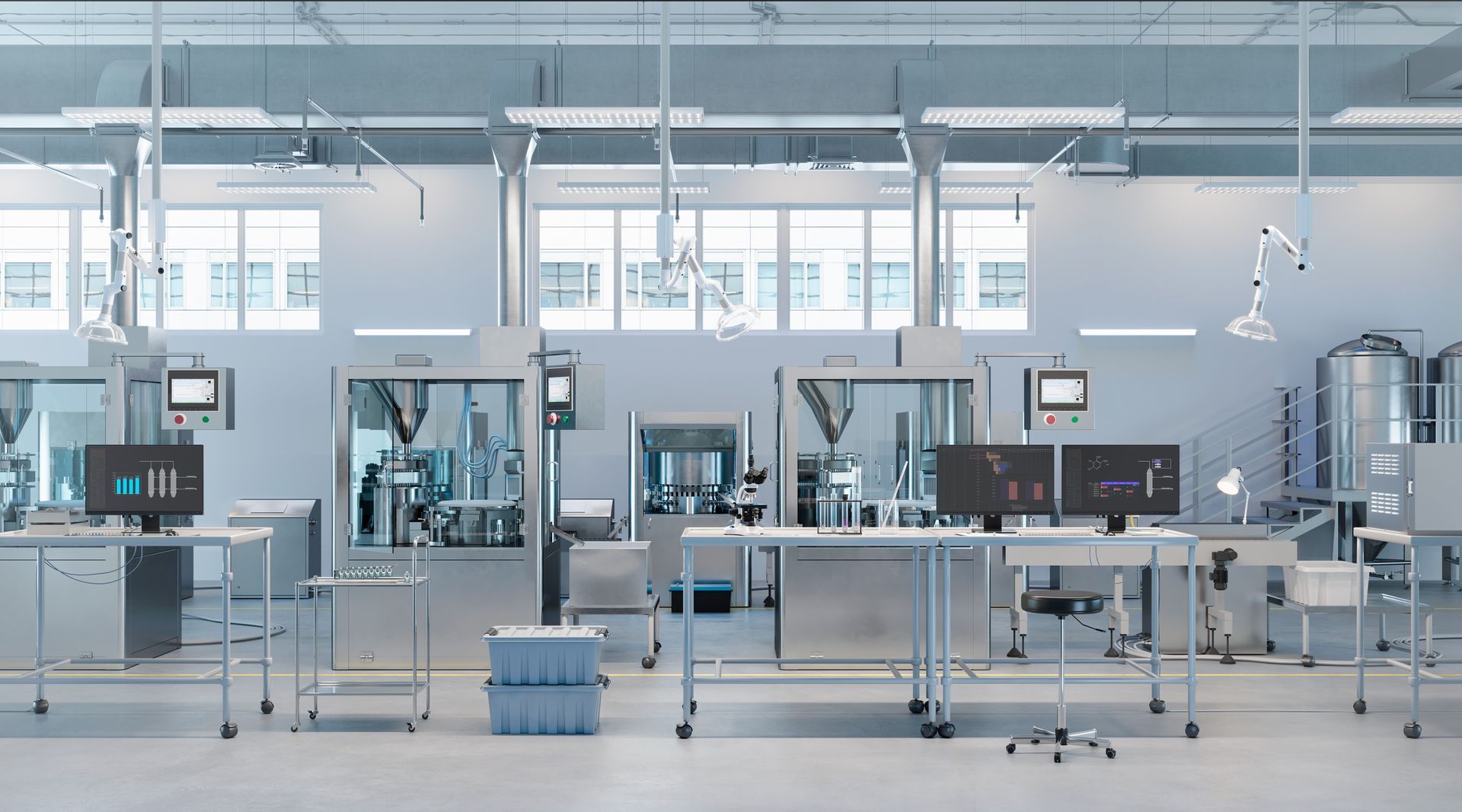 A clean, modern laboratory with stainless steel equipment, computers, and white walls.