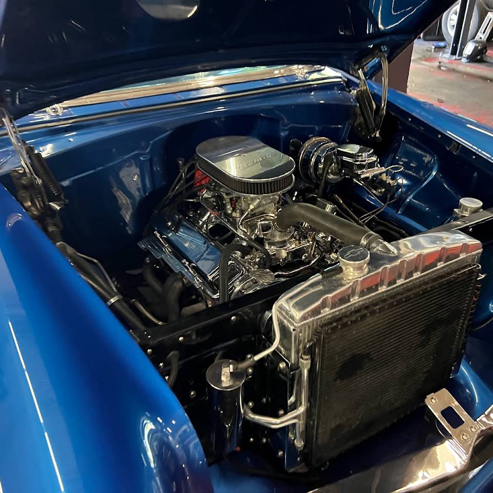 An auto with an opened hood at our repair shop