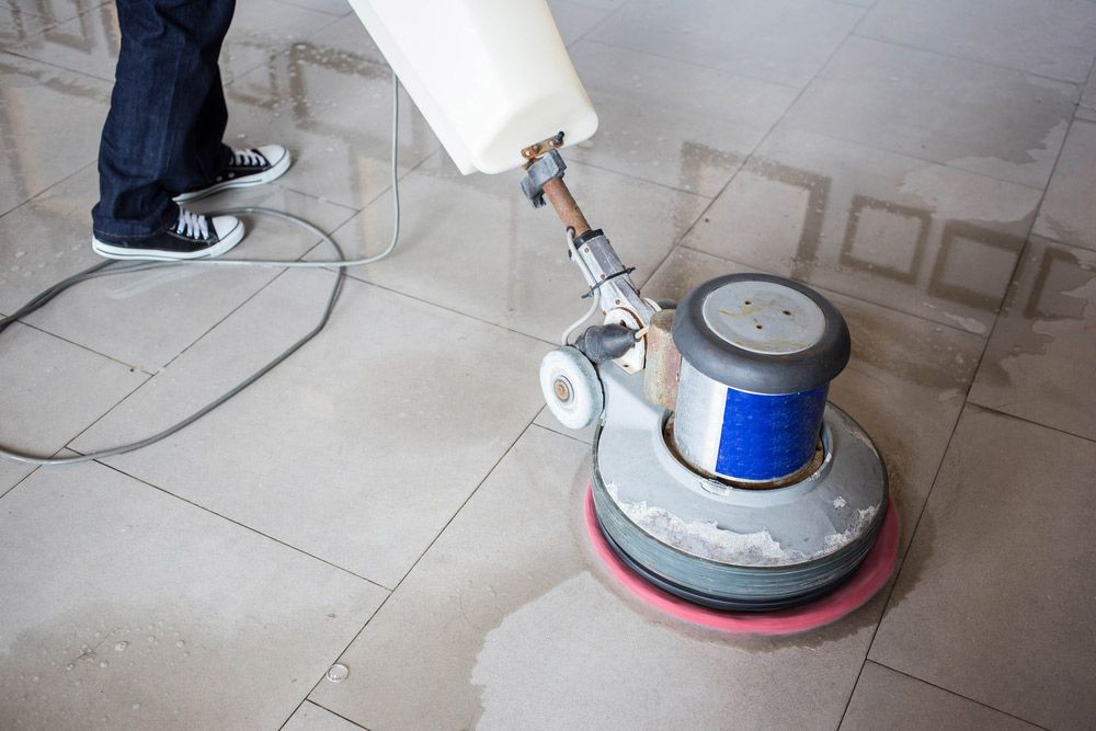 Worker Cleaning The Floor With Machine — Bearfast Bearquip In Moree NSW
