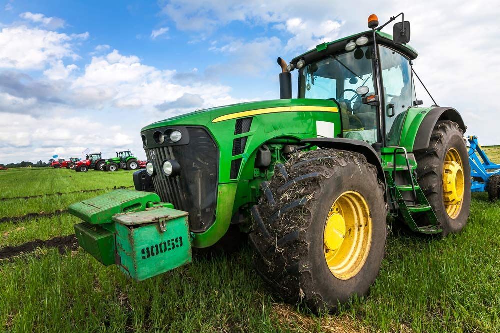 Green Tractor With Big Wheels In The Field — Bearfast Bearquip In Taminda NSW