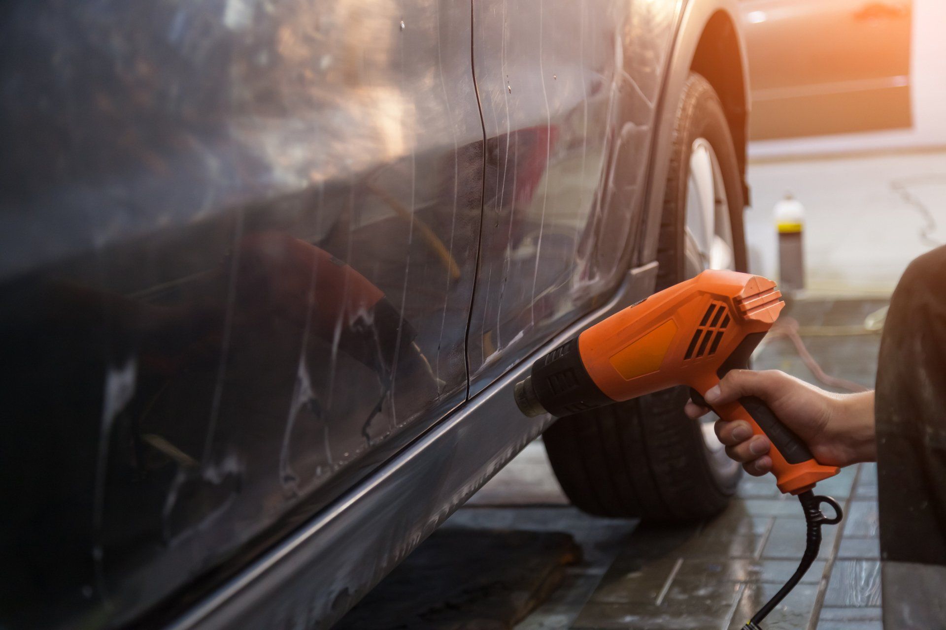 Drying With An Industrial Orange Hair Dryer The Side Of A Black Sedan Car - Morpeth - EZY2NV Window Tinting