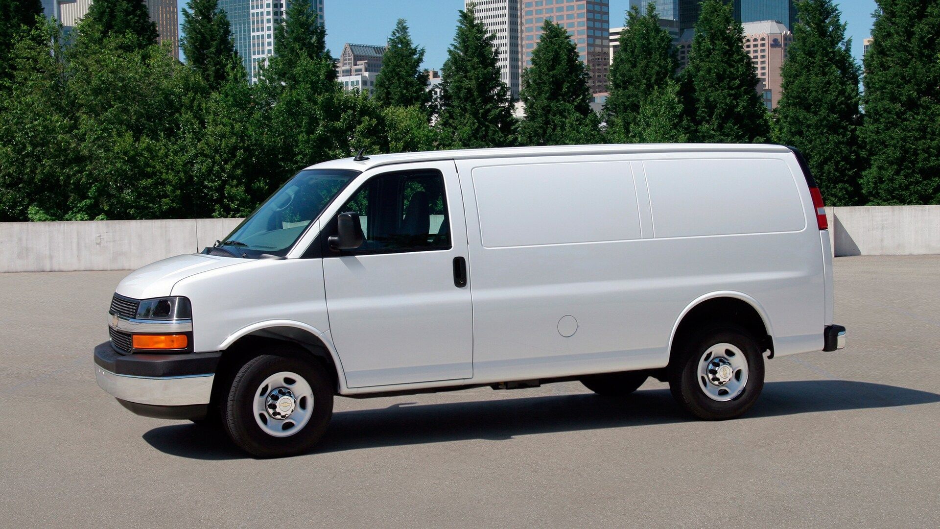 A white van parked in a parking lot with trees in the background - moving companies markham ontario	