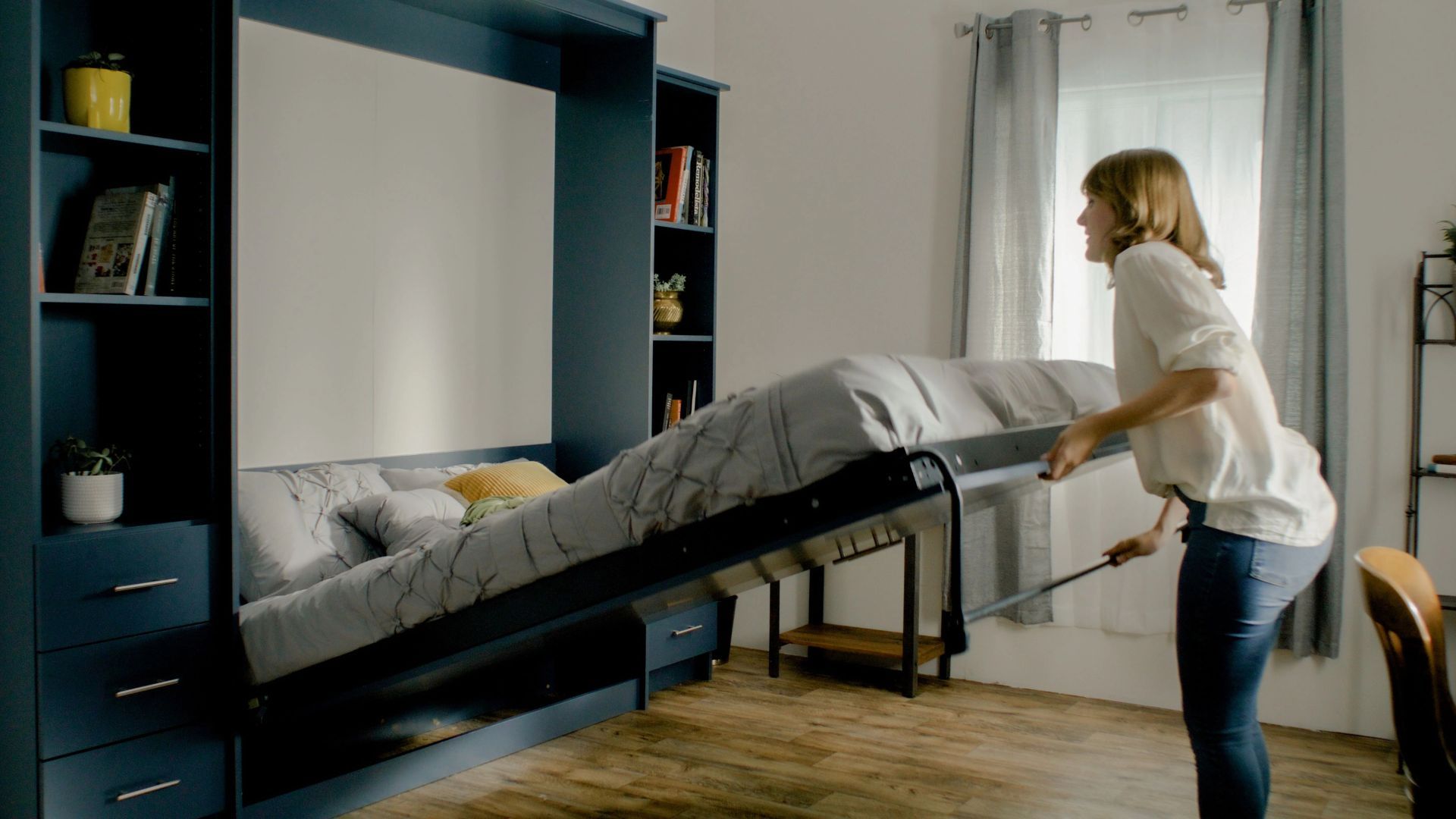 Blond lady opening a Wall Bed - same day furniture delivery toronto	