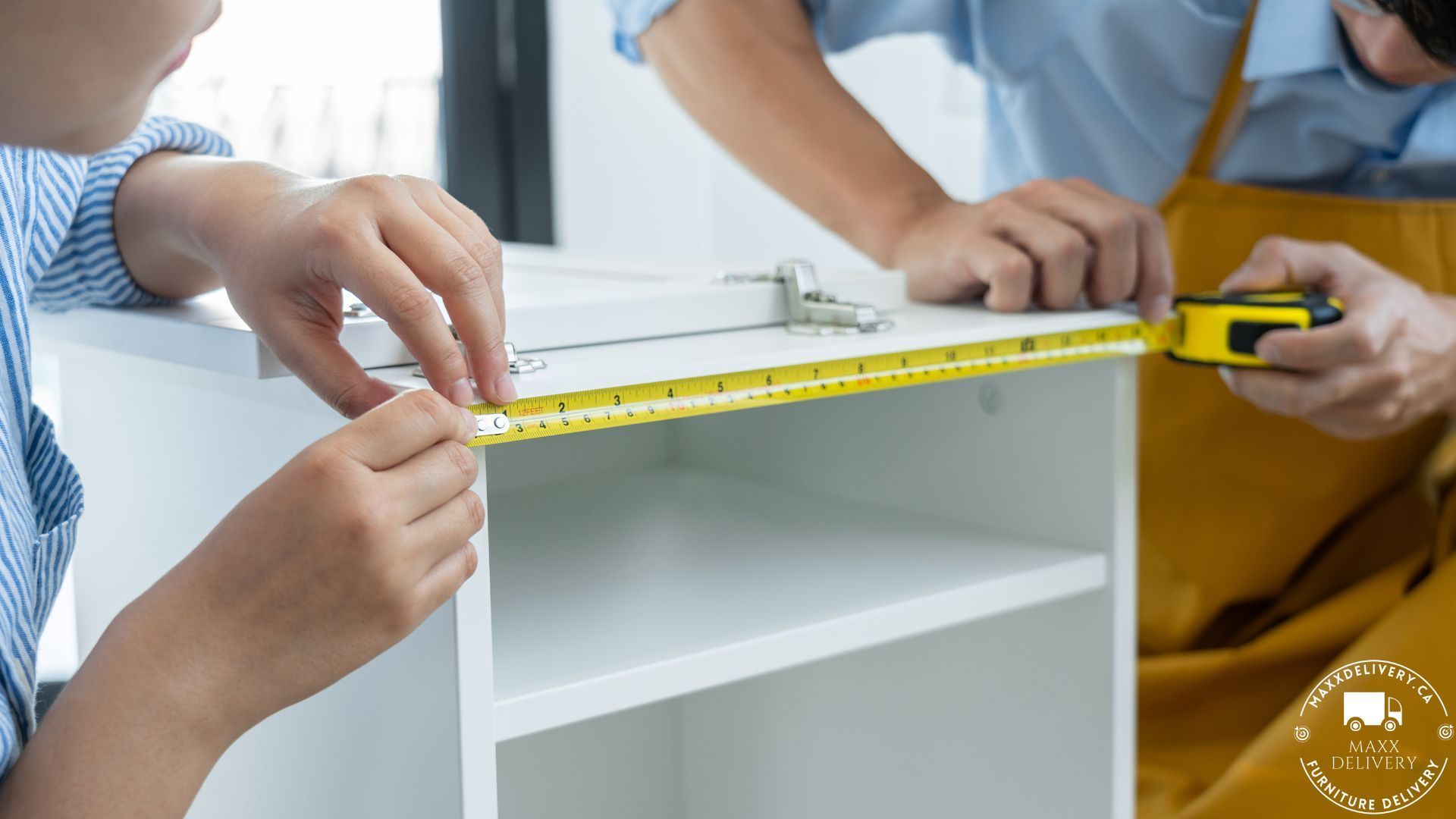 Furniture Movers measuring a cabinet with a meter - Furniture delivery Mississauga