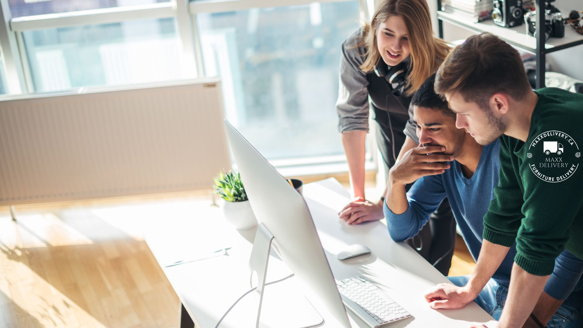 A group of people are looking at a computer screen.