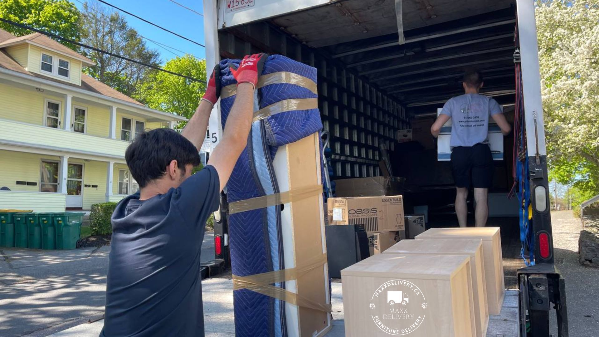 MaxxDelivery.ca’s team unloading furniture in a new home - best moving companies toronto