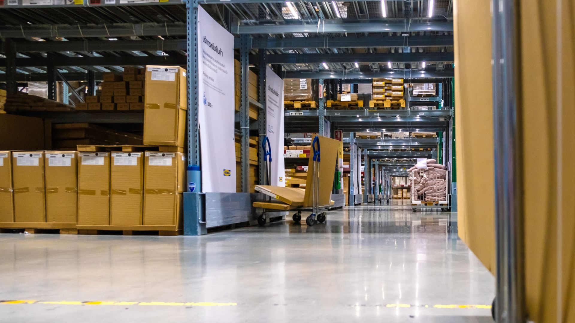 A large warehouse filled with lots of cardboard boxes