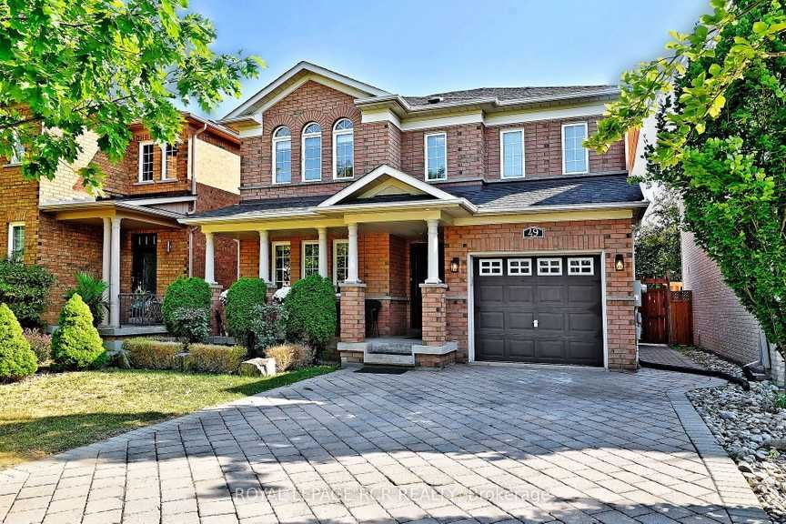 A large brick house with a brown garage door