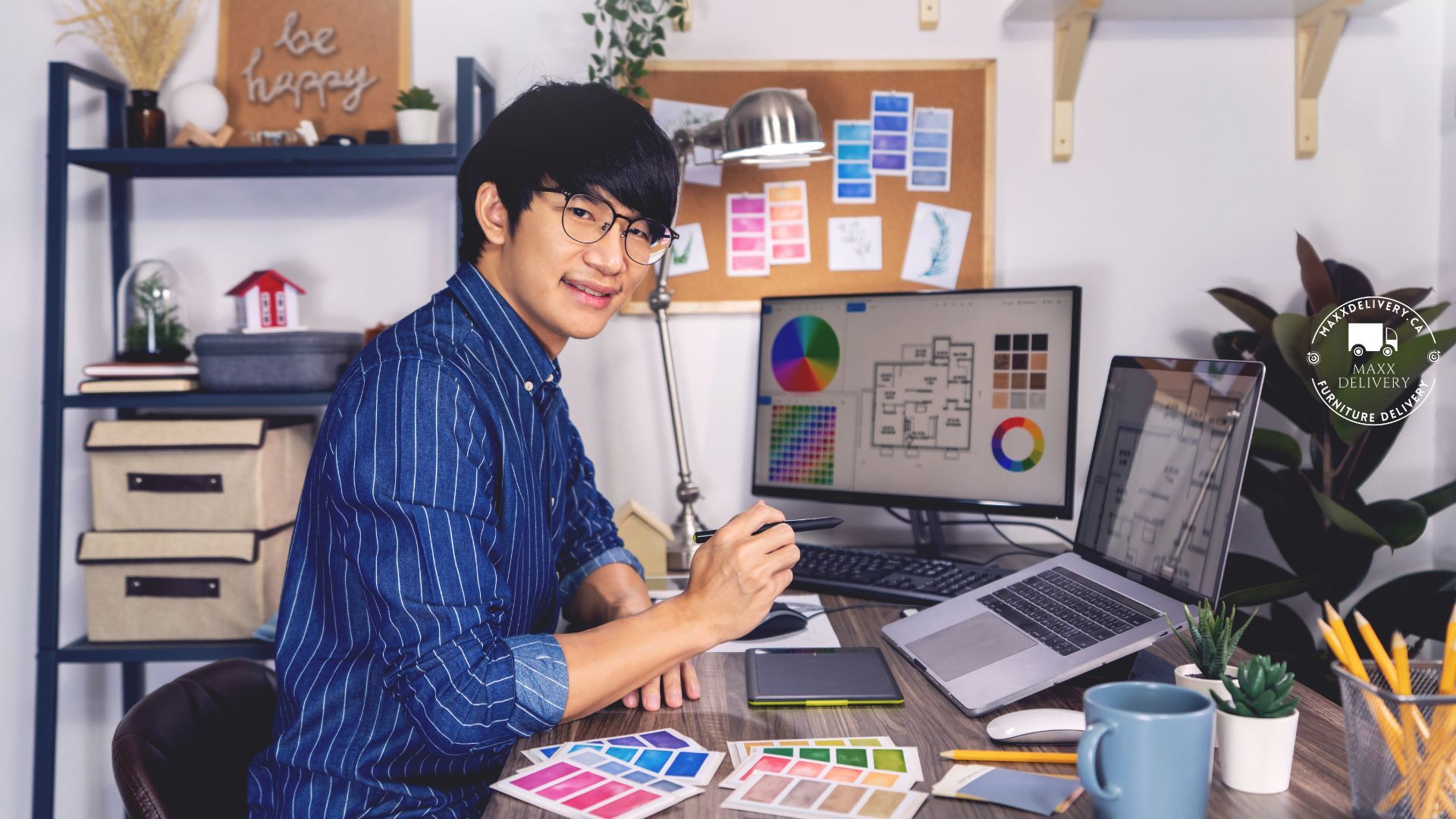 A man is sitting at a desk with a computer and a laptop.