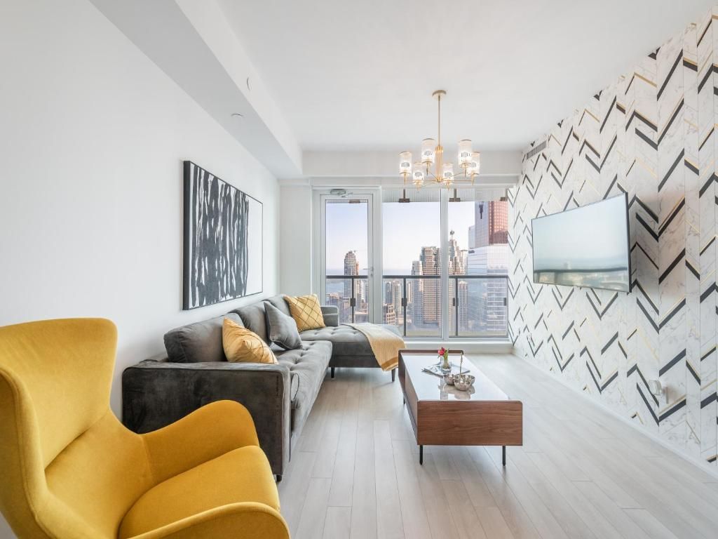 A living room with a couch and a yellow chair