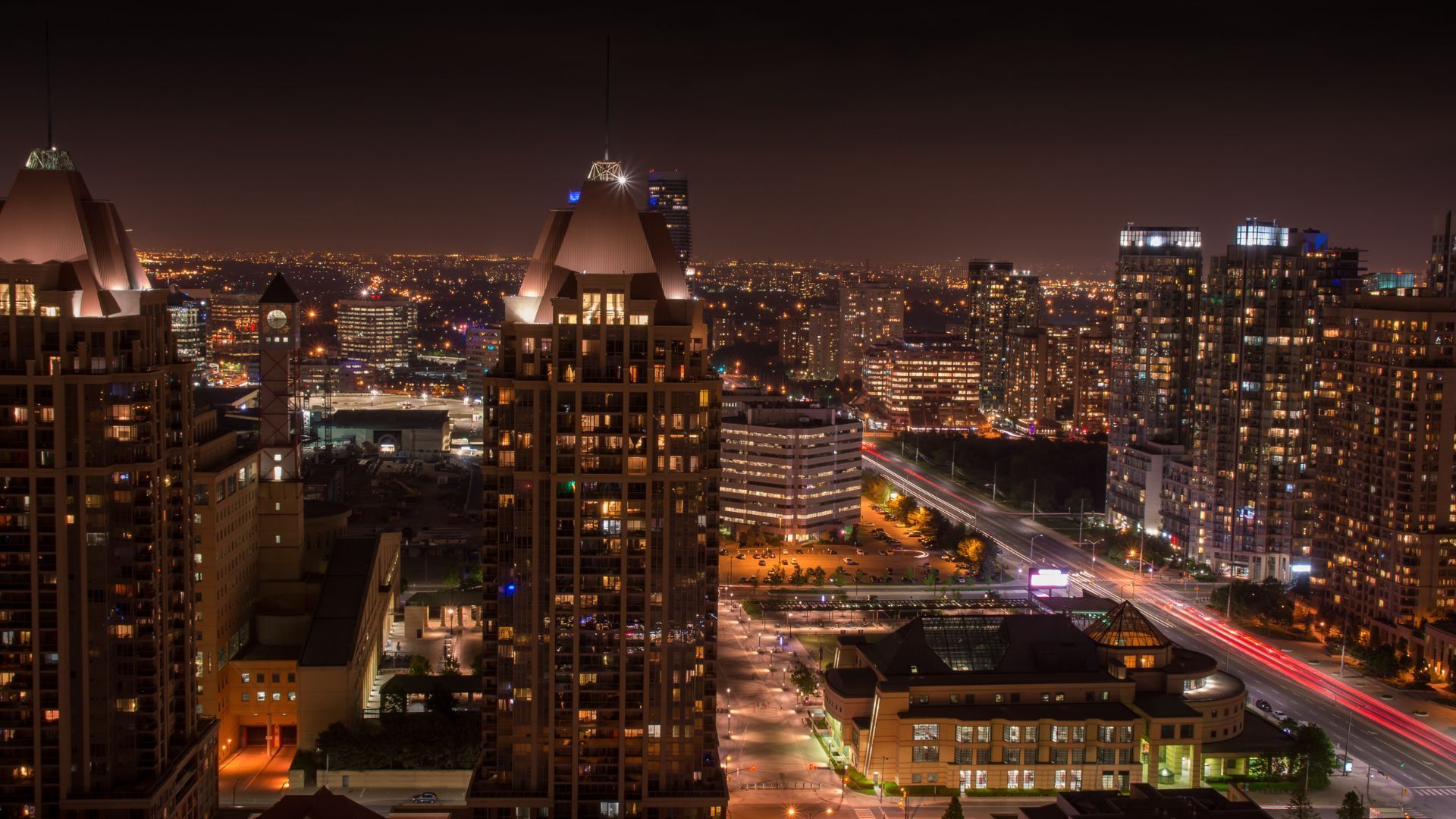 An aerial view of a city at night with buildings lit up