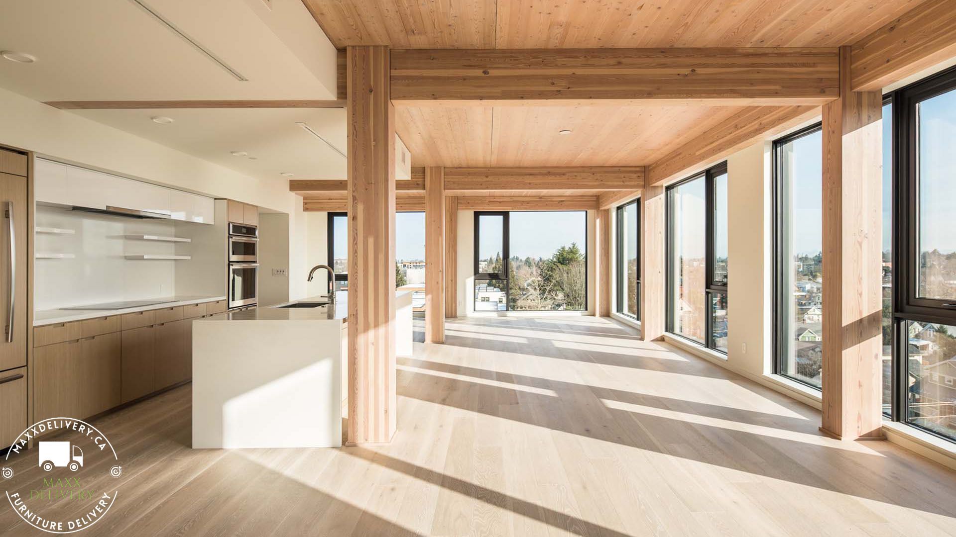 A large room with lots of windows and wooden pillars