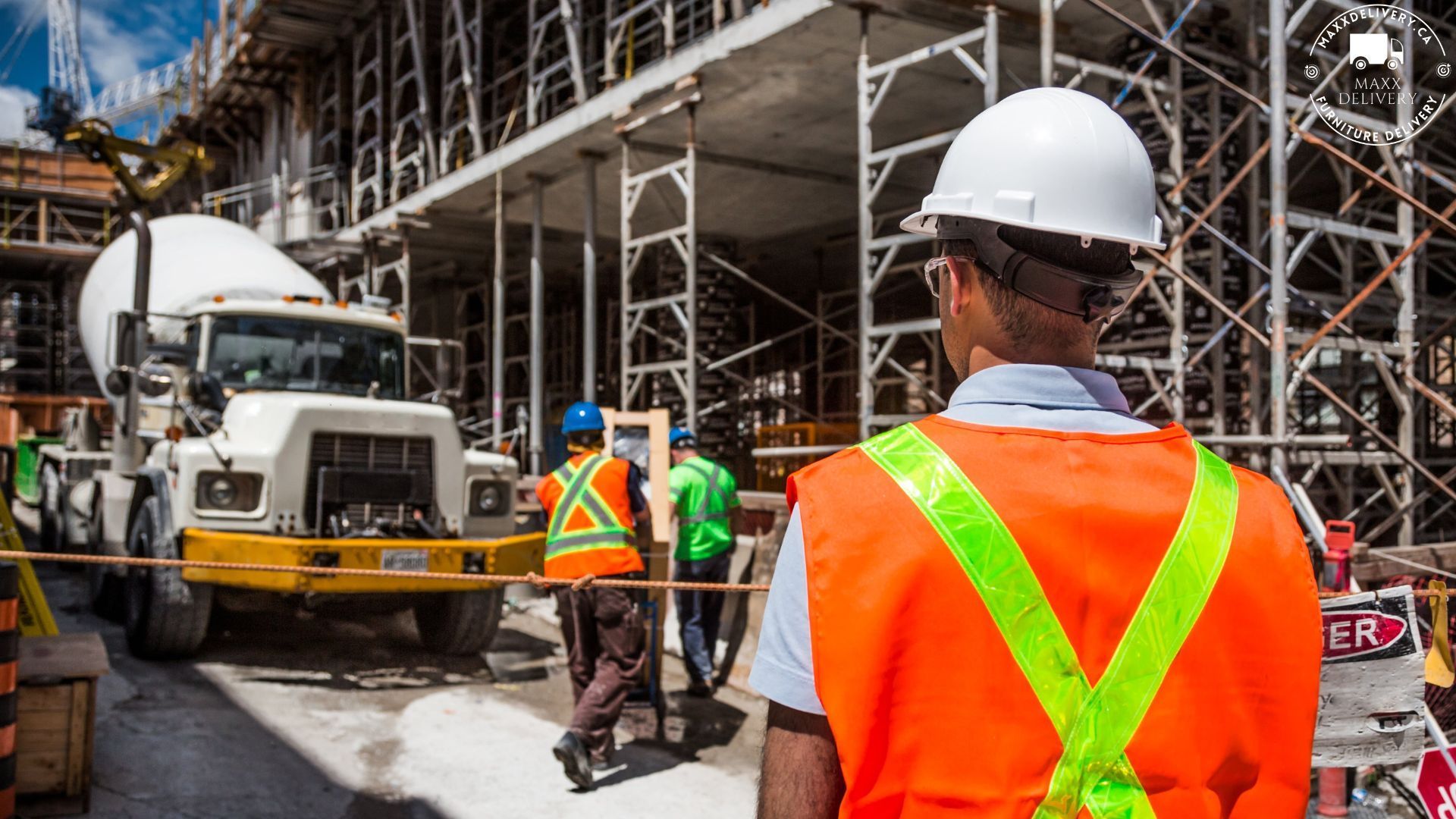 A construction worker wearing an orange vest and hard hat