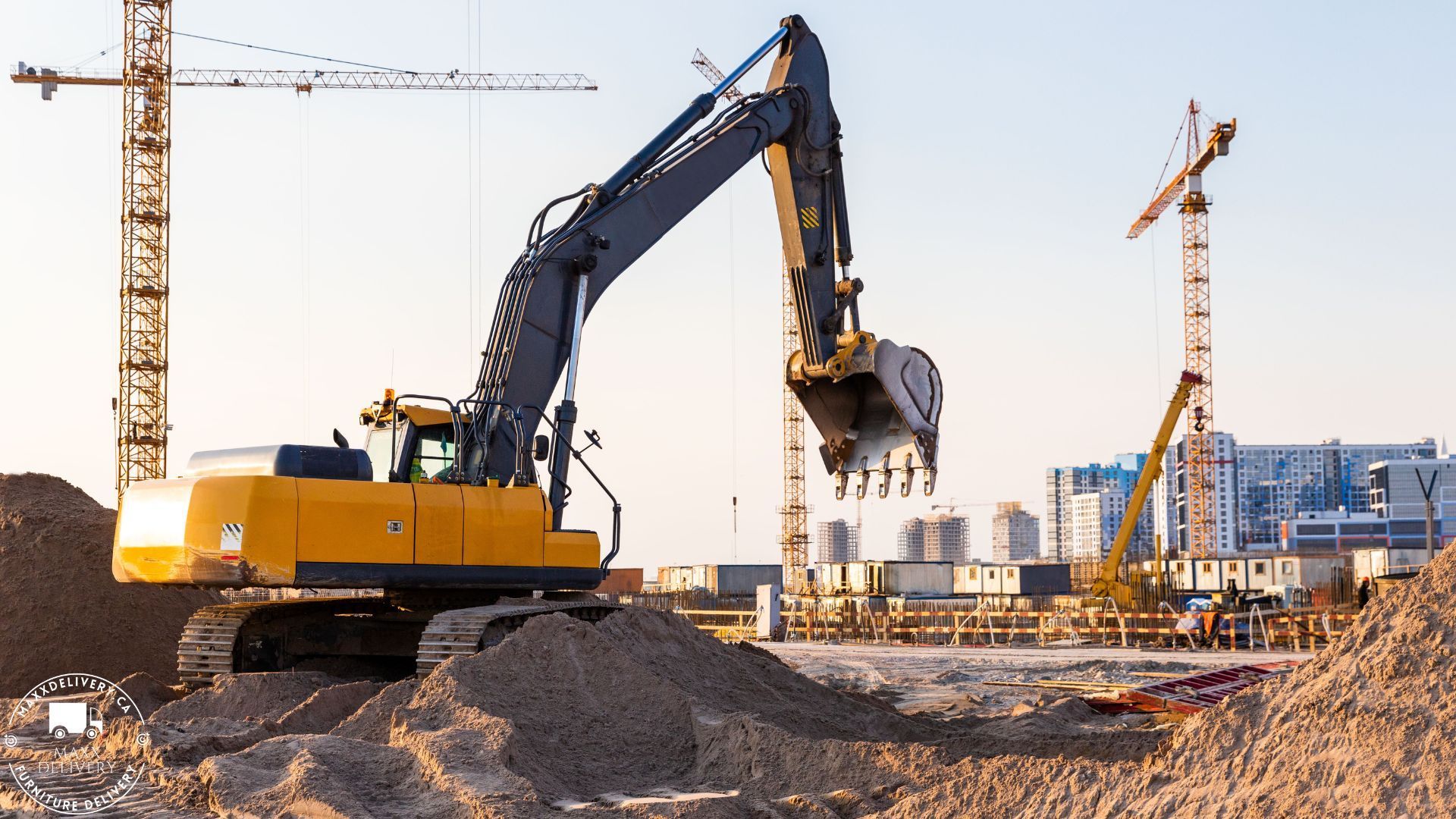 A yellow excavator is digging in a pile of dirt at a construction site