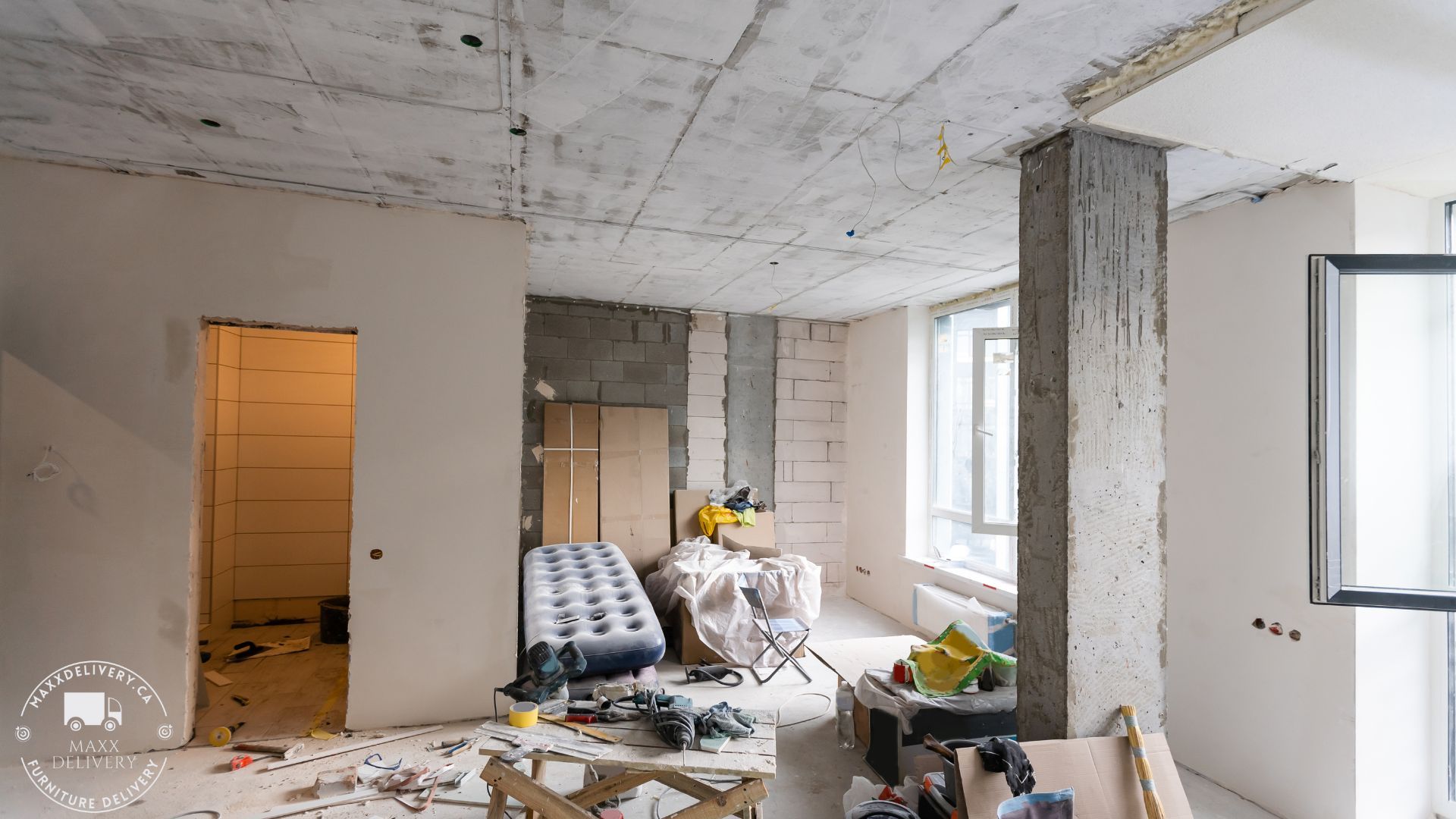 A room that is under construction with a mattress on the floor