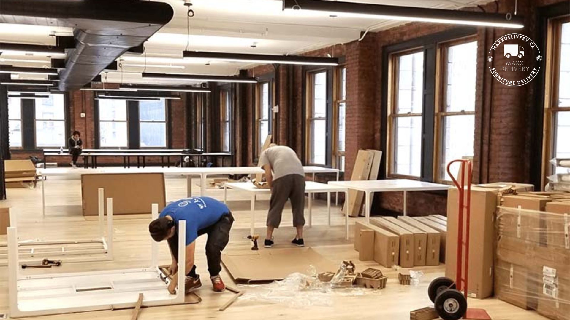 A man is working on a table in a large room.