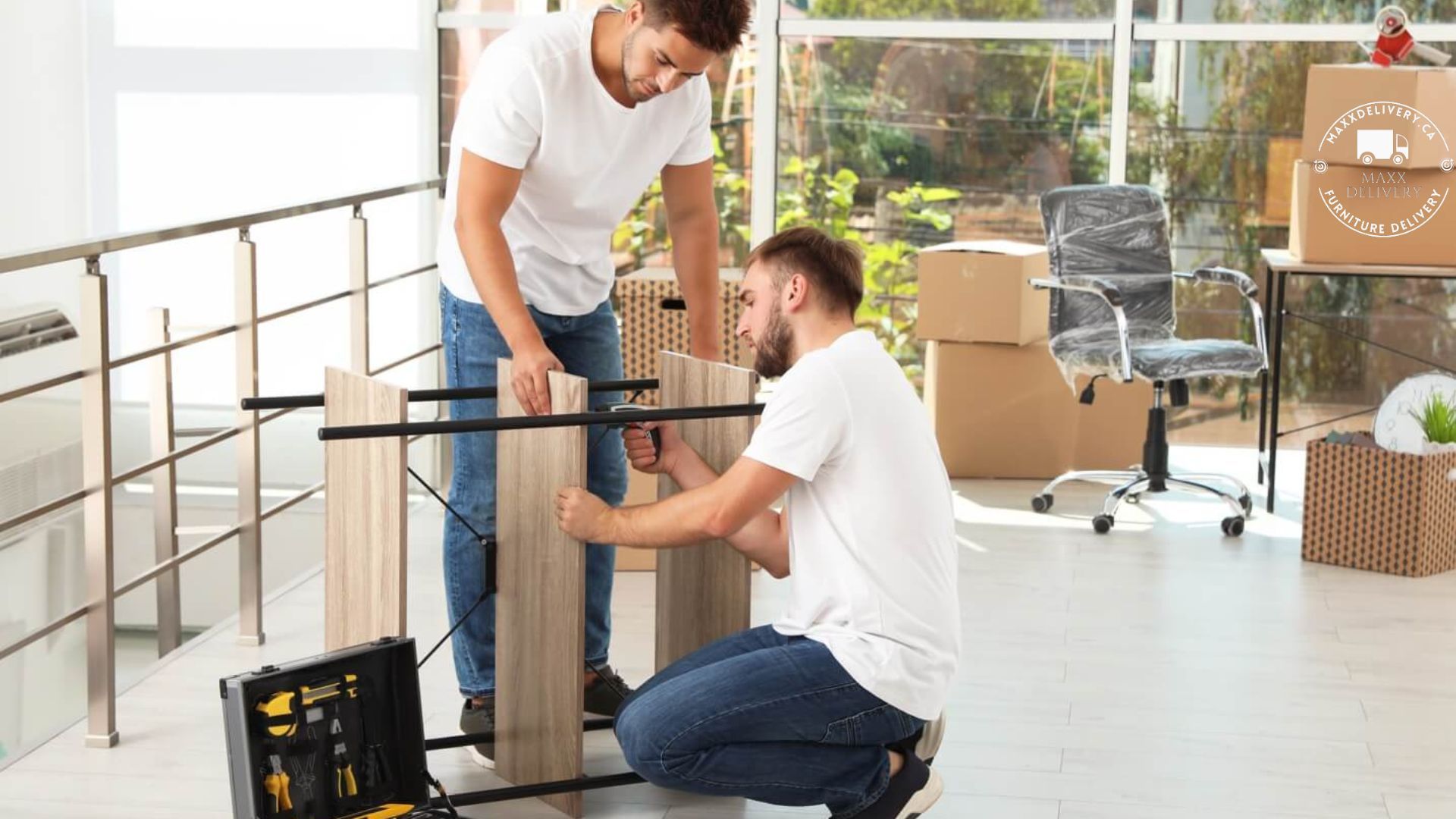 Two men are working on a piece of wood in a living room.