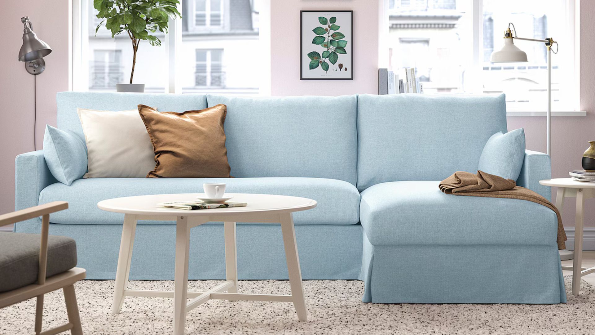 A living room with a blue couch and a white coffee table