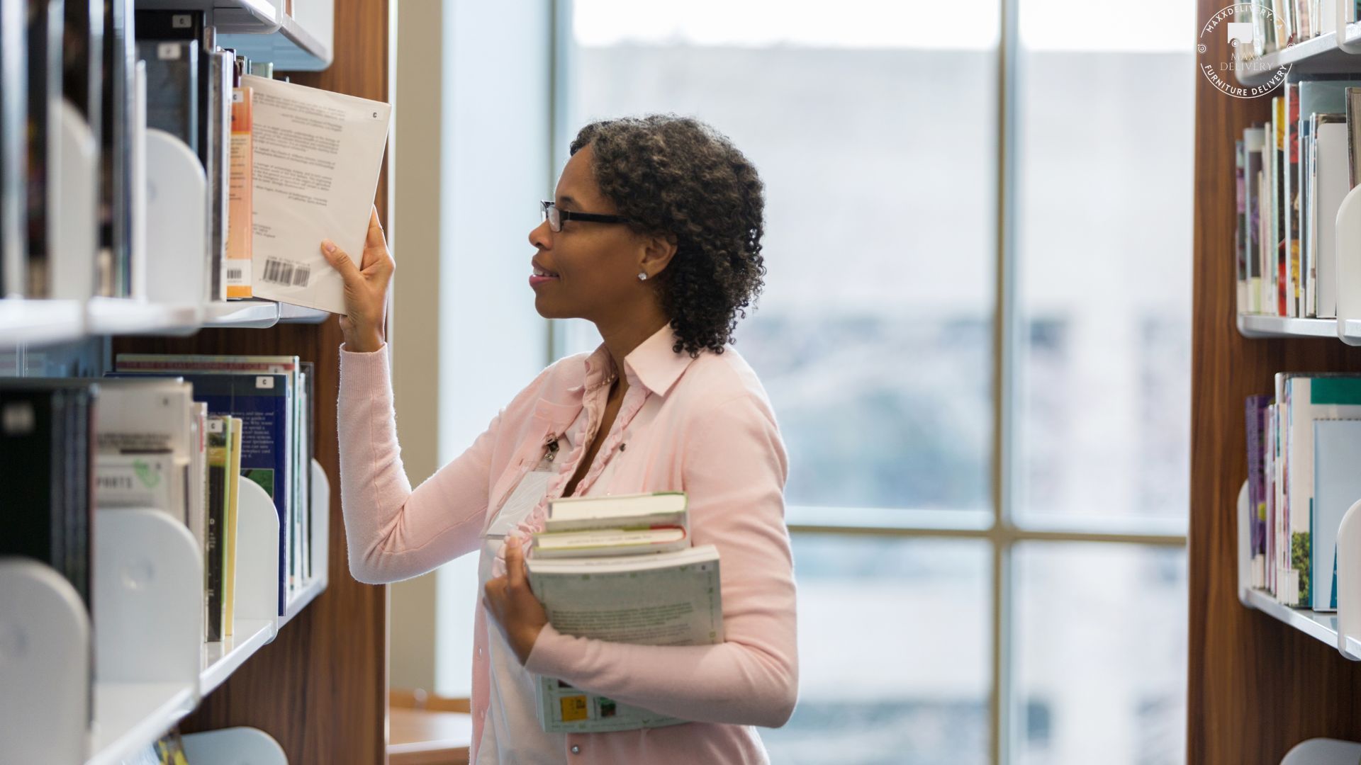 A woman is looking at a book in a library